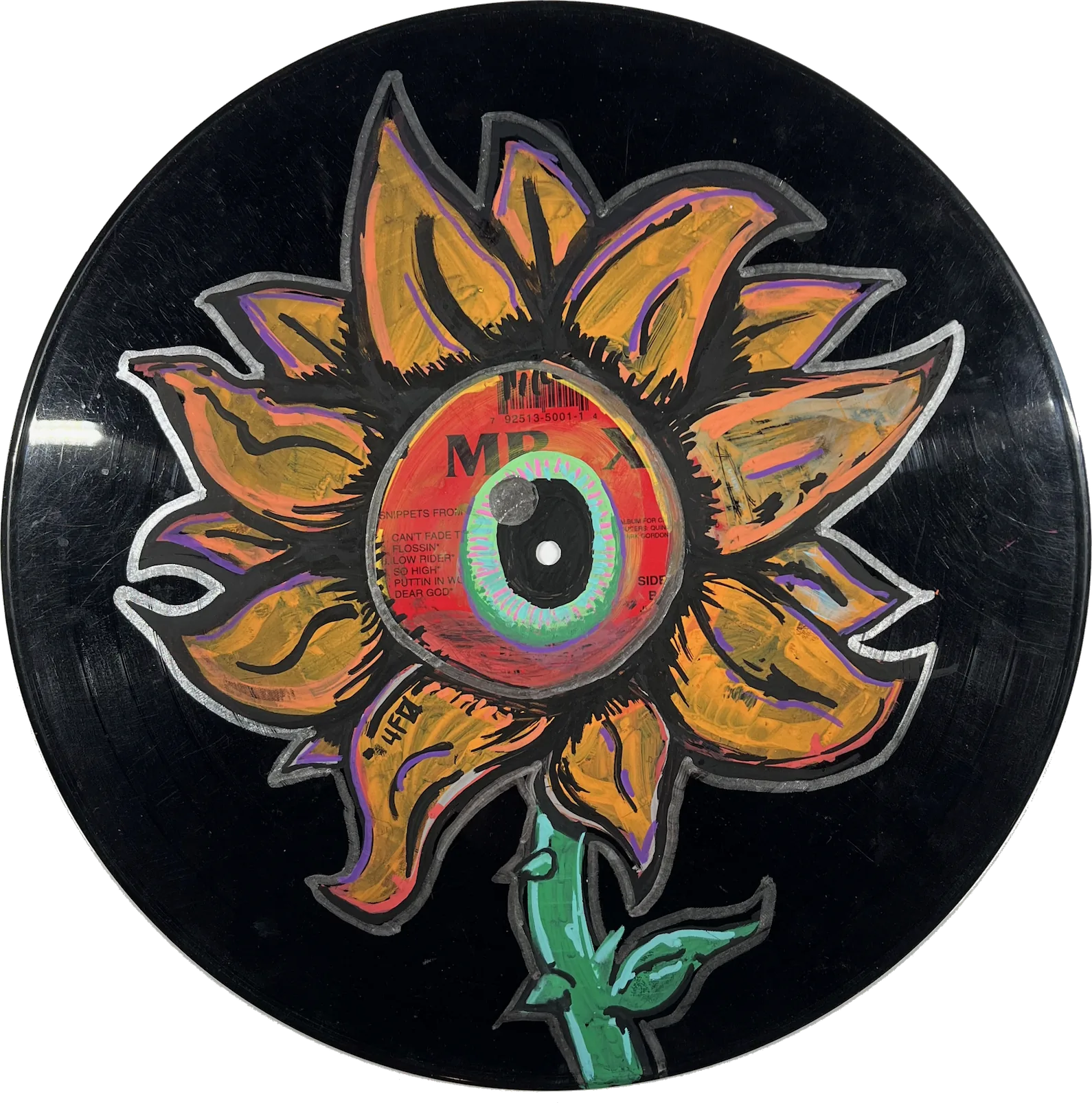 A painting of a yellow flower. The center of the flower is one red eyeball with a green iris. It is painted on a black vinyl record