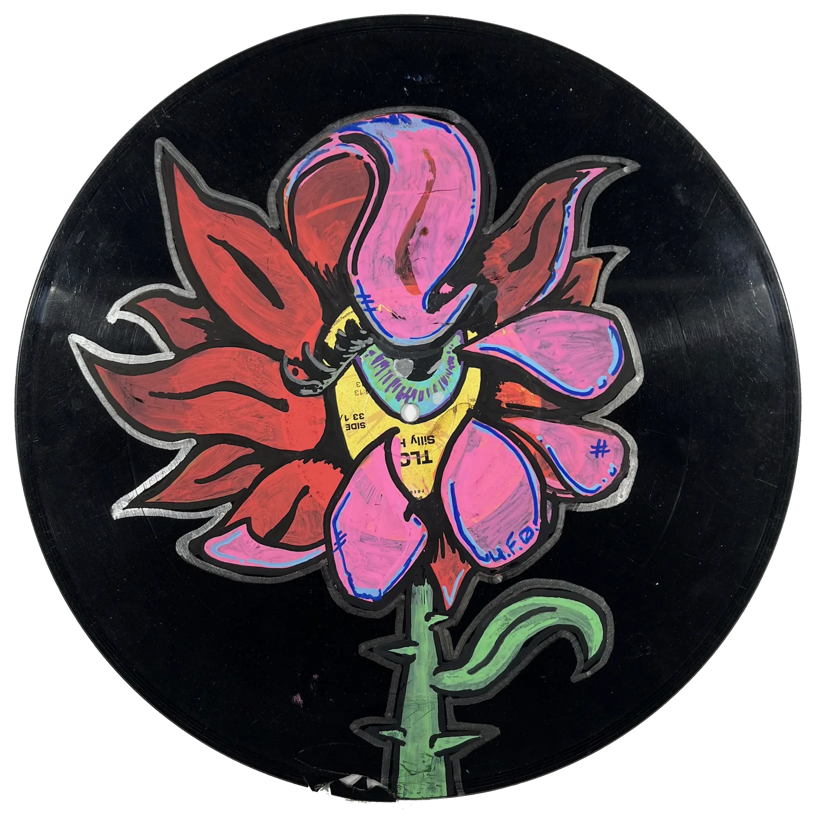 A painting of a red and pink flower. The center of the flower is one yellow eyeball with a green iris. It is painted on a black vinyl record