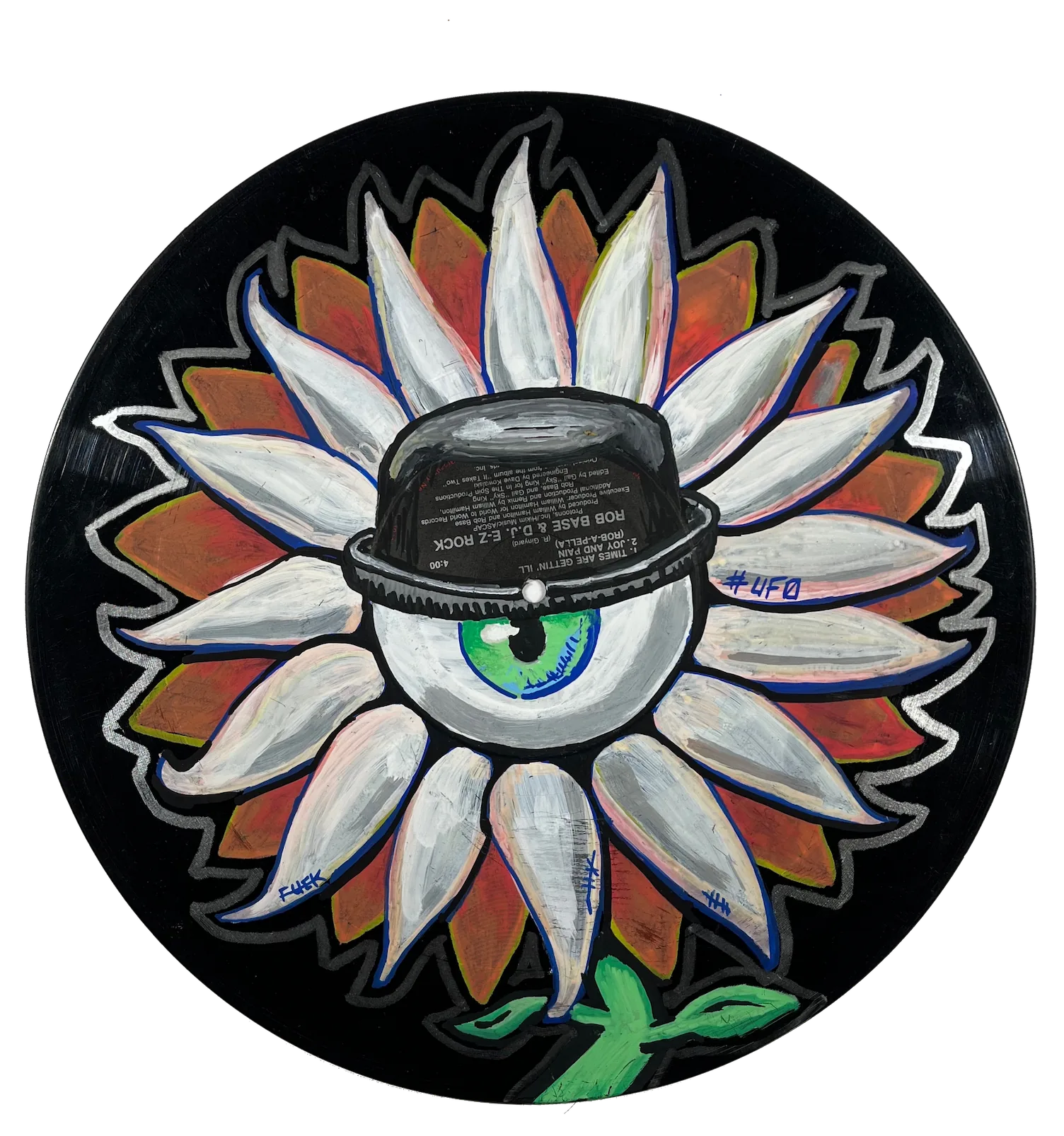 A painting of a flower. The center of the flower is one eyeball with a green iris wearing a hat. It is painted on a black vinyl record